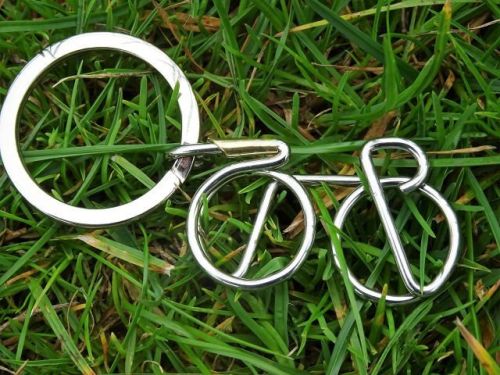 Stainless steel Racer Keyring shown on grass